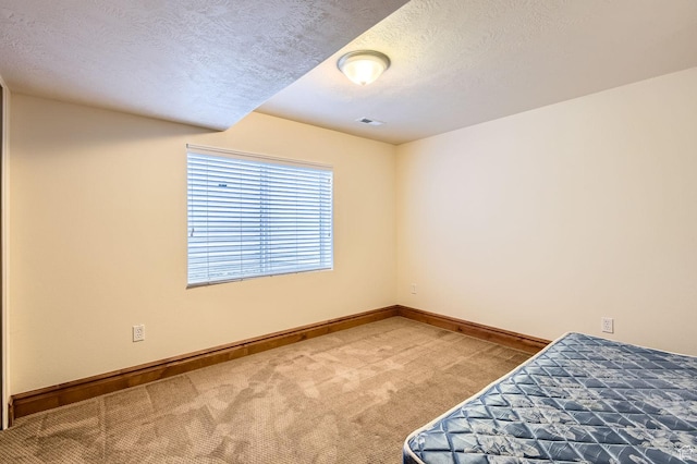 4628 N Long Way, Eagle Mountain, UT 84005 - unfurnished bedroom featuring carpet floors, a textured ceiling, and baseboards