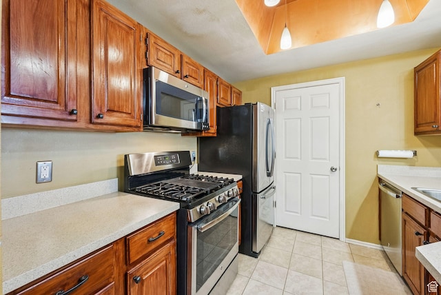 900 Bitner Rd Unit D32, Park City, UT 84098 - kitchen with stainless steel appliances, light countertops, light tile patterned floors, and brown cabinets