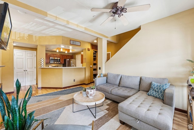 900 Bitner Rd Unit D32, Park City, UT 84098 - living room with light wood finished floors, a ceiling fan, and baseboards