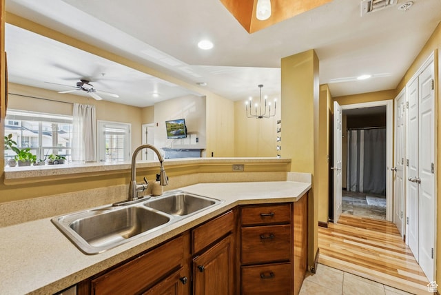 900 Bitner Rd Unit D32, Park City, UT 84098 - kitchen featuring a sink, light countertops, light tile patterned floors, brown cabinets, and a ceiling fan