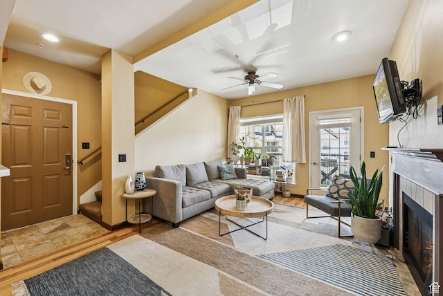 900 Bitner Rd Unit D32, Park City, UT 84098 - living room featuring stairs, a tiled fireplace, ceiling fan, recessed lighting, and light wood finished floors