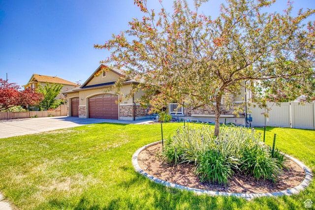 2155 N 170 W, Tooele, UT 84074 - view of front facade featuring driveway, an attached garage, stone siding, and stucco siding