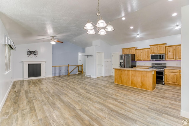2155 N 170 W, Tooele, UT 84074 - kitchen featuring appliances with stainless steel finishes, a kitchen island, vaulted ceiling, open floor plan, and ceiling fan