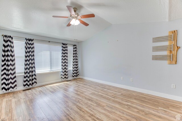 2155 N 170 W, Tooele, UT 84074 - spare room featuring wood finished floors, a ceiling fan, lofted ceiling, baseboards, and radiator heating unit