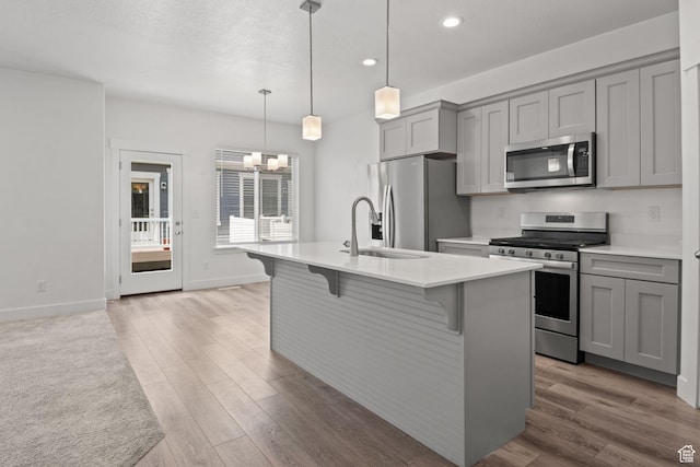 274 W 530 N Unit 329, Vineyard, UT 84059 - kitchen featuring stainless steel appliances, gray cabinetry, a sink, recessed lighting, and a chandelier