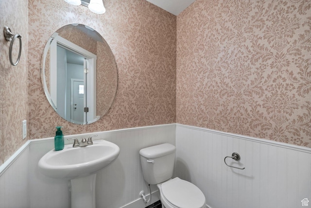 2185 W Crestview Dr, Lehi, UT 84043 - bathroom with wallpapered walls, a wainscoted wall, and toilet