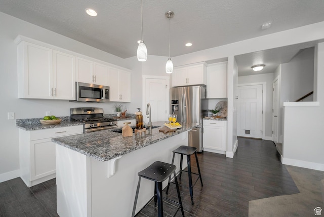 2185 W Crestview Dr, Lehi, UT 84043 - kitchen featuring stainless steel appliances, a breakfast bar area, stone countertops, dark wood finished floors, and recessed lighting