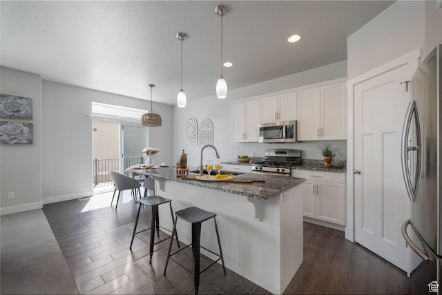 2185 W Crestview Dr, Lehi, UT 84043 - kitchen featuring stainless steel appliances, a sink, dark stone counters, white cabinets, and recessed lighting