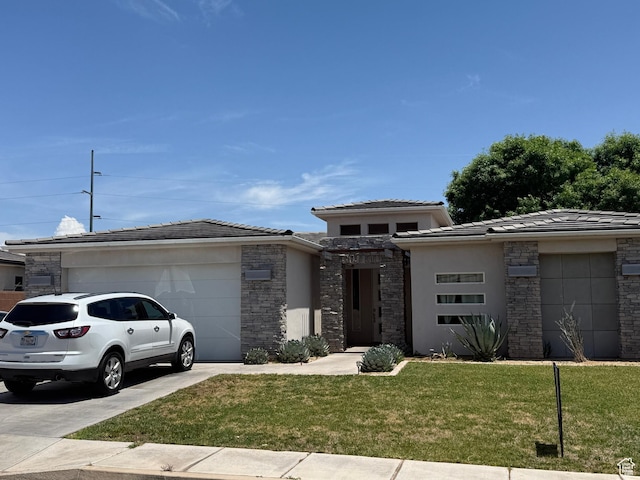 410 N 2720 E, St George, UT 84790 - prairie-style house featuring a garage, concrete driveway, a front lawn, and stone siding