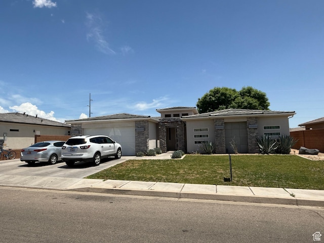 410 N 2720 E, St George, UT 84790 - view of front of property with an attached garage, a front yard, stone siding, driveway, and a tile roof