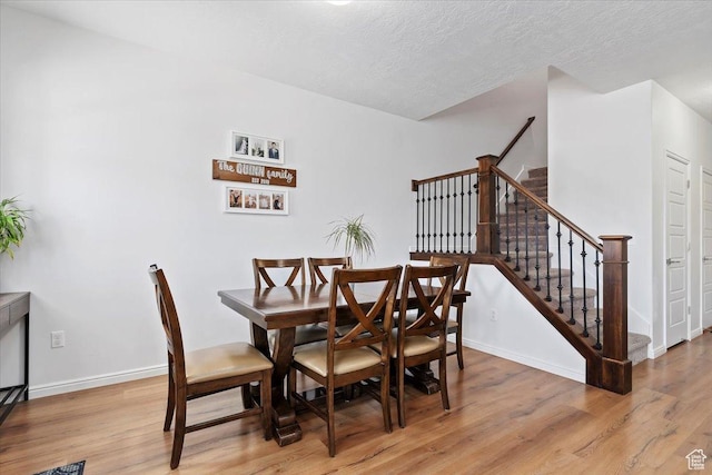 1252 W Cinch Way S, Bluffdale, UT 84065 - dining area featuring light wood-type flooring, stairs, baseboards, and a textured ceiling