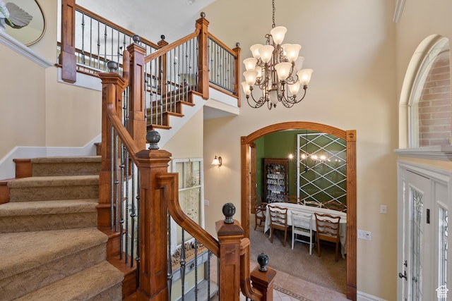 8149 S 2425 E, South Weber, UT 84405 - foyer entrance featuring a towering ceiling, carpet floors, a chandelier, stairway, and arched walkways