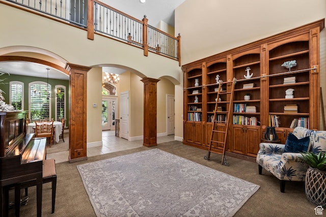 8149 S 2425 E, South Weber, UT 84405 - living area with arched walkways, ornate columns, carpet, and a high ceiling