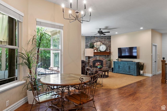 8149 S 2425 E, South Weber, UT 84405 - dining area featuring wood finished floors, a ceiling fan, a large fireplace, a chandelier, and recessed lighting
