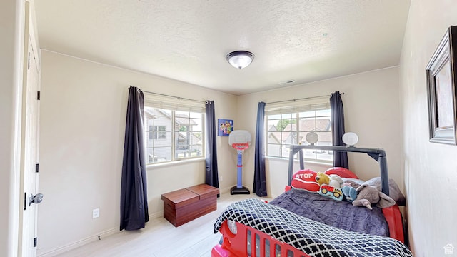 2515 W 450 S Unit 7, Springville, UT 84663 - bedroom featuring a textured ceiling, baseboards, and light wood finished floors