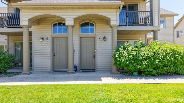 2515 W 450 S Unit 7, Springville, UT 84663 - doorway to property with a balcony, a shingled roof, and a yard