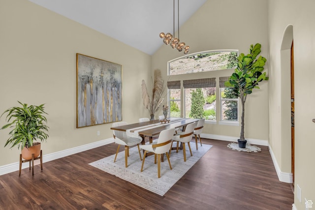 673 S Parkway Dr, North Salt Lake, UT 84054 - dining area featuring wood finished floors, arched walkways, high vaulted ceiling, and baseboards