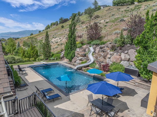 673 S Parkway Dr, North Salt Lake, UT 84054 - view of pool with a patio, a water slide, and a mountain view