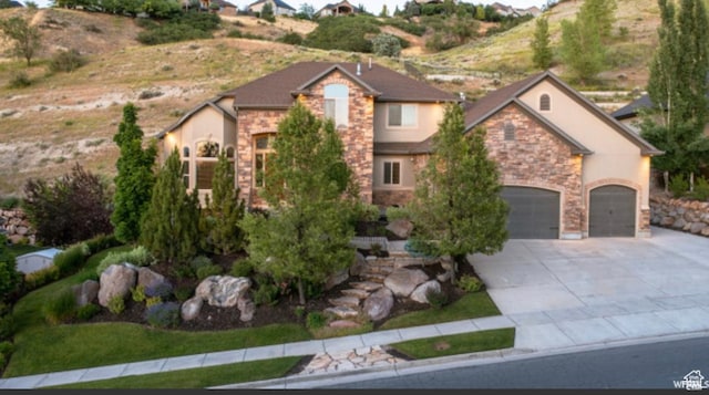 673 S Parkway Dr, North Salt Lake, UT 84054 - view of front of home featuring stone siding, concrete driveway, and stucco siding