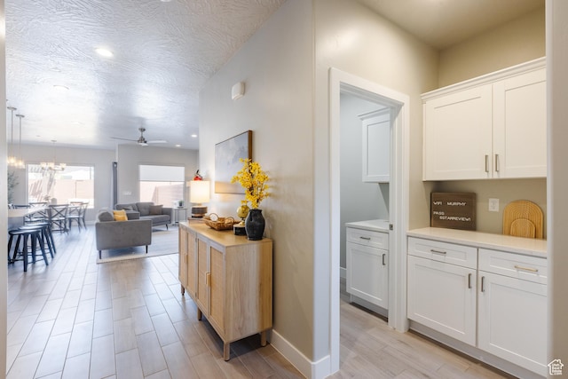 266 N 2020 W # 74, Hurricane, UT 84737 - hallway with light wood-style floors, a chandelier, recessed lighting, and baseboards