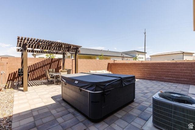 266 N 2020 W # 74, Hurricane, UT 84737 - fenced backyard with a hot tub, cooling unit, a patio, a pergola, and outdoor dining space
