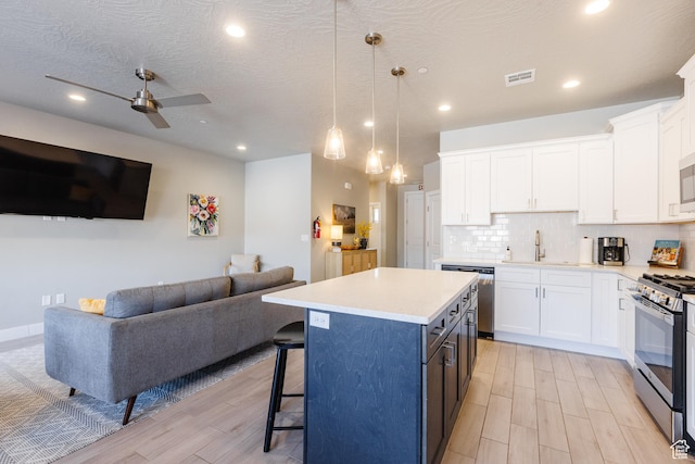 266 N 2020 W # 74, Hurricane, UT 84737 - kitchen with appliances with stainless steel finishes, open floor plan, a sink, white cabinets, and recessed lighting