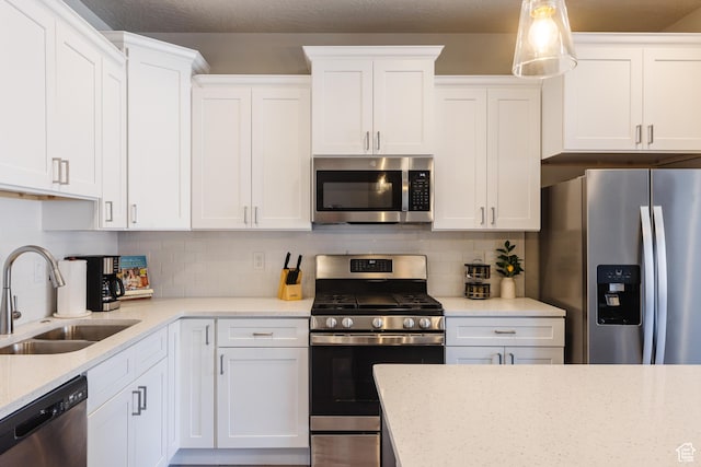 266 N 2020 W # 74, Hurricane, UT 84737 - kitchen with appliances with stainless steel finishes, a sink, white cabinets, backsplash, and light stone countertops