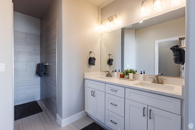 266 N 2020 W # 74, Hurricane, UT 84737 - bathroom featuring double vanity, baseboards, tile patterned flooring, and tiled shower