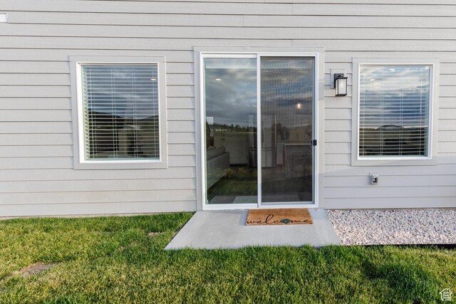 356 W Oregon Trail Dr Unit 100, Garden City, UT 84028 - view of exterior entry with a lawn