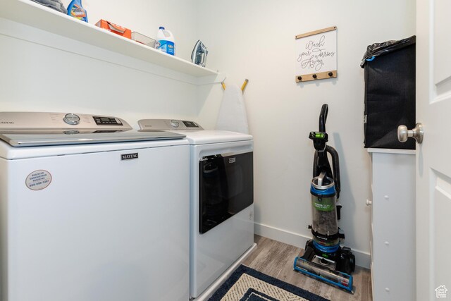 356 W Oregon Trail Dr Unit 100, Garden City, UT 84028 - washroom featuring washer and dryer, wood finished floors, and baseboards