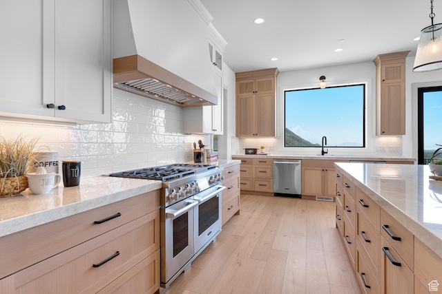3851 W Box Elder Cir, Alpine, UT 84004 - kitchen featuring stainless steel appliances, custom exhaust hood, light stone countertops, light brown cabinetry, and recessed lighting
