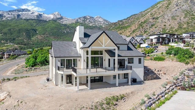3851 W Box Elder Cir, Alpine, UT 84004 - rear view of house featuring a balcony, stucco siding, a chimney, and a shingled roof