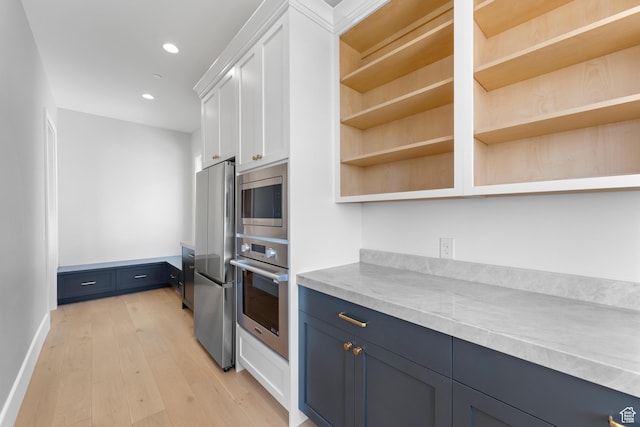 3851 W Box Elder Cir, Alpine, UT 84004 - kitchen with stainless steel appliances, open shelves, white cabinetry, light wood-style flooring, and light countertops