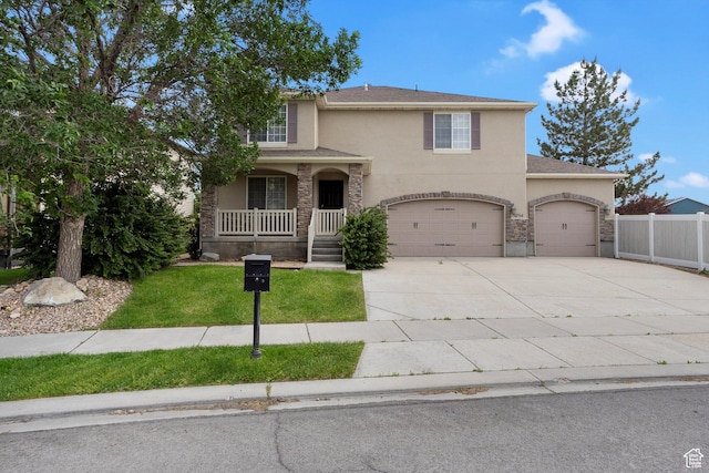1754 E Cedar Trails Way, Eagle Mountain, UT 84005 - traditional-style home with stucco siding, covered porch, concrete driveway, and a garage