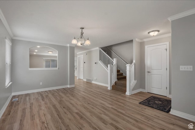 1754 E Cedar Trails Way, Eagle Mountain, UT 84005 - foyer featuring a chandelier, wood finished floors, stairway, baseboards, and crown molding