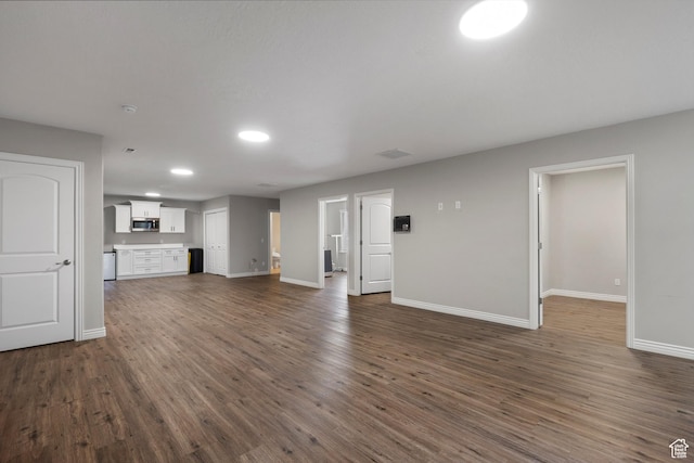 1754 E Cedar Trails Way, Eagle Mountain, UT 84005 - unfurnished living room featuring baseboards, recessed lighting, and dark wood-type flooring