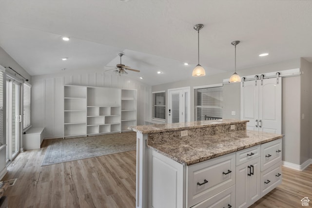 1754 E Cedar Trails Way, Eagle Mountain, UT 84005 - kitchen with a ceiling fan, light wood-style flooring, open floor plan, lofted ceiling, and white cabinets