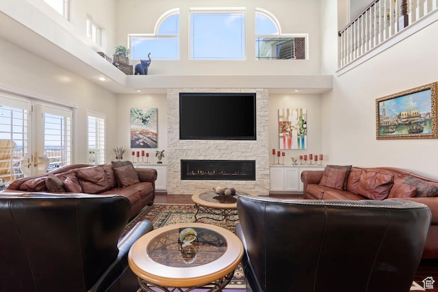4715 S 1500 E, Ogden, UT 84403 - living room featuring a high ceiling, a stone fireplace, and wood finished floors