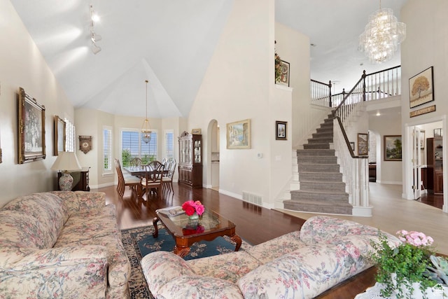 4715 S 1500 E, Ogden, UT 84403 - living area with a towering ceiling, a chandelier, stairs, arched walkways, and wood finished floors