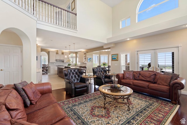 4715 S 1500 E, Ogden, UT 84403 - living area featuring hardwood / wood-style floors, a high ceiling, and arched walkways