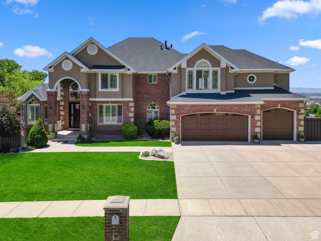 4715 S 1500 E, Ogden, UT 84403 - traditional home with an attached garage, a front yard, driveway, and stucco siding