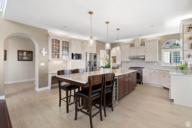 4715 S 1500 E, Ogden, UT 84403 - kitchen with stainless steel appliances, backsplash, and light wood-style flooring