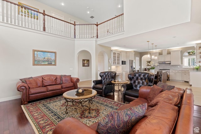 4715 S 1500 E, Ogden, UT 84403 - living room featuring arched walkways, baseboards, light wood-type flooring, recessed lighting, and a high ceiling