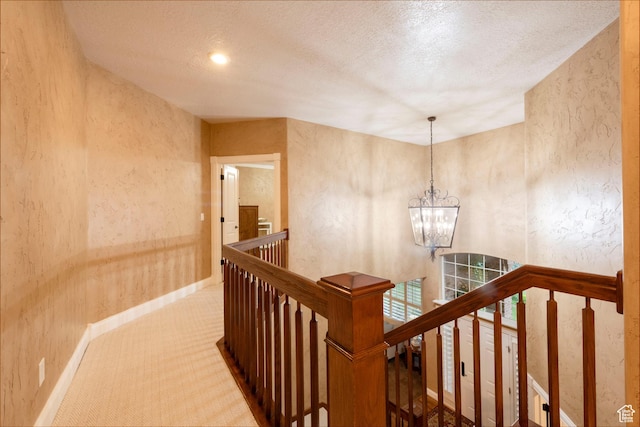13279 S Berry Ln, Draper, UT 84020 - hall featuring an upstairs landing, carpet floors, a chandelier, baseboards, and a textured wall