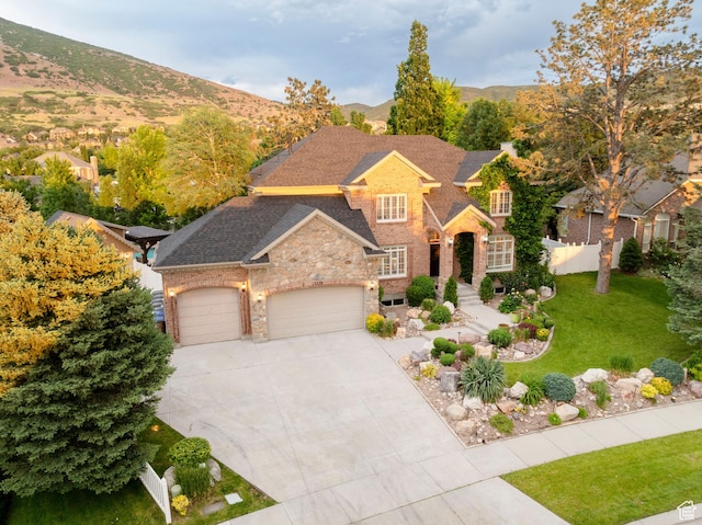 13279 S Berry Ln, Draper, UT 84020 - traditional-style house with an attached garage, driveway, stone siding, a mountain view, and brick siding
