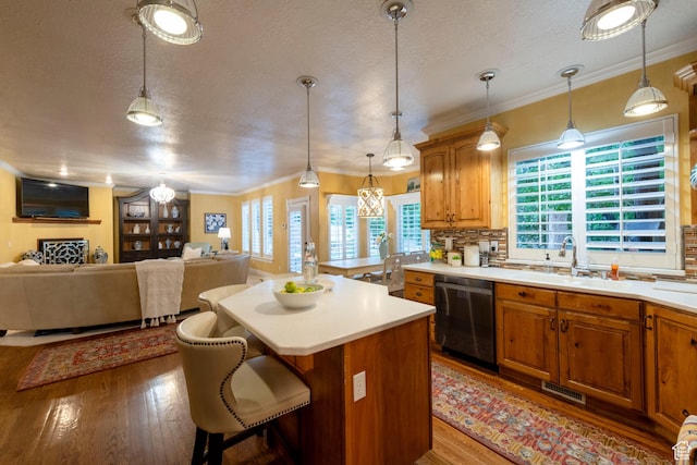 13279 S Berry Ln, Draper, UT 84020 - kitchen with dishwasher, a sink, light wood-style flooring, light countertops, and a kitchen island