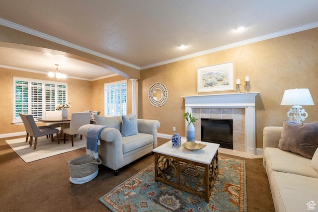 13279 S Berry Ln, Draper, UT 84020 - carpeted living room with a chandelier, a fireplace, baseboards, arched walkways, and crown molding