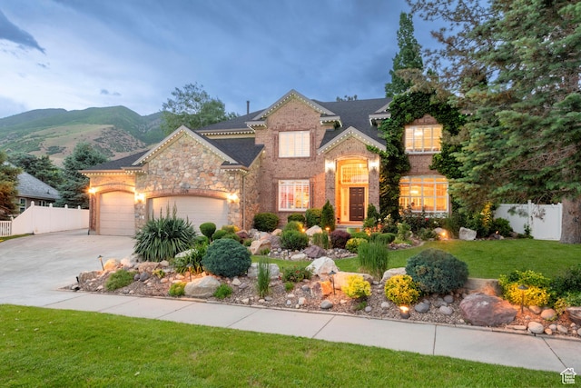 13279 S Berry Ln, Draper, UT 84020 - view of front of home featuring driveway, an attached garage, stone siding, brick siding, and a mountain view
