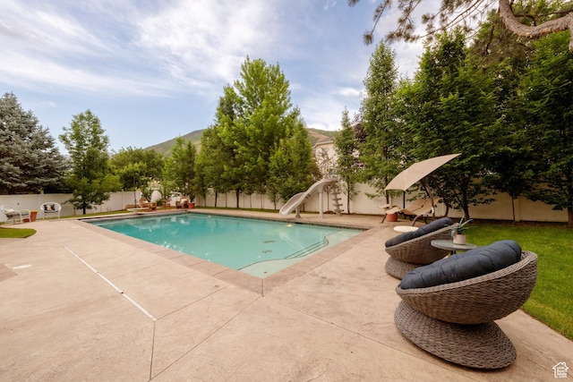13279 S Berry Ln, Draper, UT 84020 - view of pool with a water slide, a fenced backyard, a patio area, and a mountain view