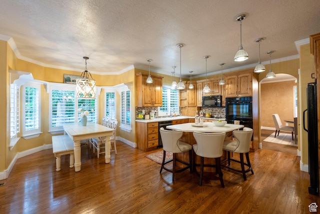 13279 S Berry Ln, Draper, UT 84020 - kitchen featuring black appliances, an island with sink, tasteful backsplash, a textured ceiling, and light countertops